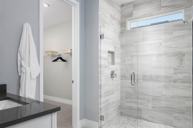 bathroom with vanity and a shower with door