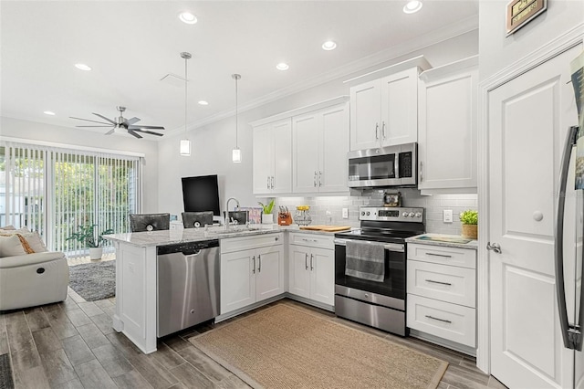 kitchen with white cabinets, ceiling fan, kitchen peninsula, and appliances with stainless steel finishes