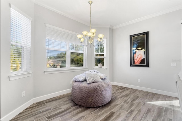 living area featuring hardwood / wood-style floors, an inviting chandelier, and ornamental molding