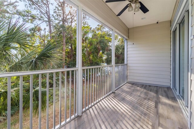 unfurnished sunroom with ceiling fan