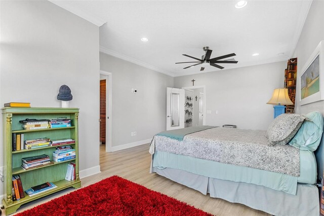 bedroom with ceiling fan, light wood-type flooring, and crown molding