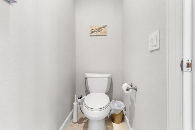 bathroom with tile patterned flooring and toilet