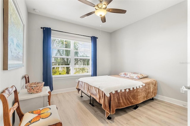 bedroom with light hardwood / wood-style flooring and ceiling fan