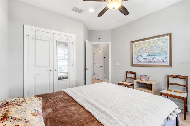 bedroom featuring ceiling fan, light hardwood / wood-style flooring, and a closet