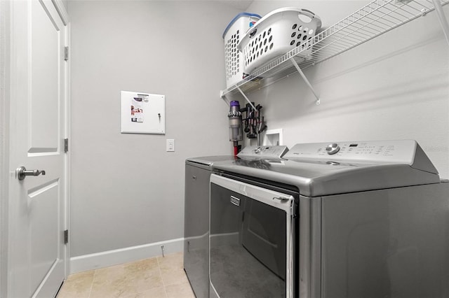 washroom featuring light tile patterned floors and washing machine and dryer