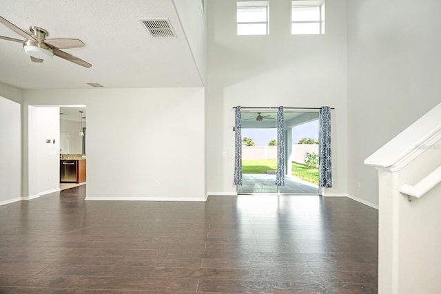 entrance foyer with ceiling fan, dark wood-type flooring, and a textured ceiling