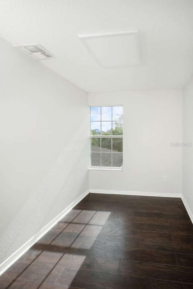 unfurnished room featuring dark hardwood / wood-style flooring