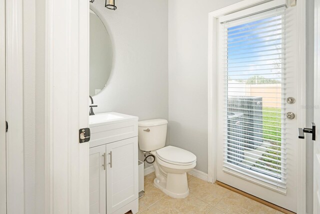 bathroom with tile patterned flooring, vanity, and toilet