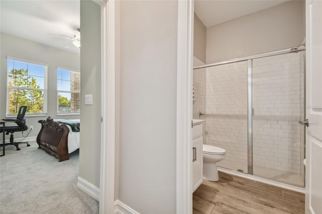 bathroom with vanity, ceiling fan, toilet, walk in shower, and wood-type flooring