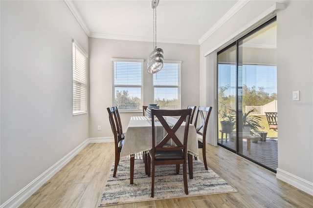 dining room featuring crown molding and light hardwood / wood-style flooring