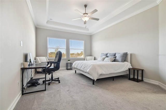 bedroom with ceiling fan, a raised ceiling, carpet floors, and ornamental molding