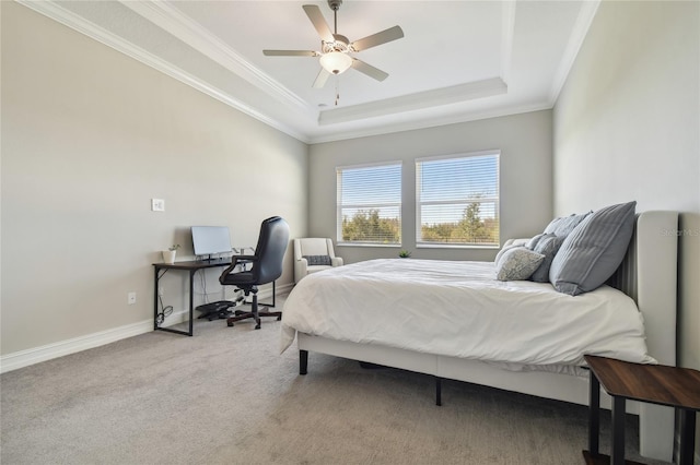 bedroom featuring carpet flooring, a raised ceiling, ceiling fan, and ornamental molding