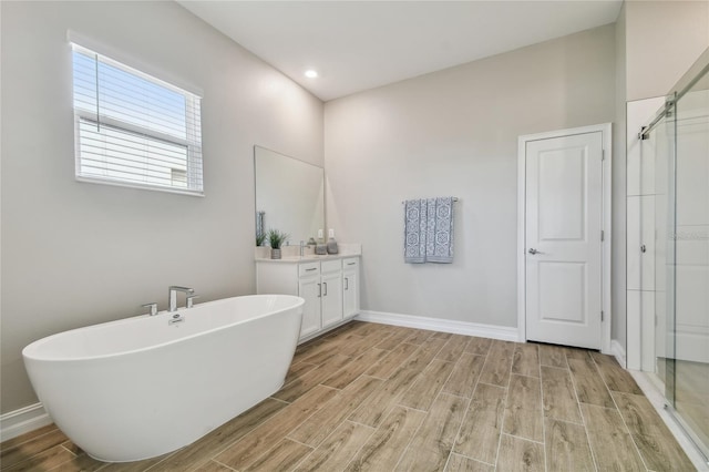 bathroom featuring hardwood / wood-style floors, vanity, and independent shower and bath