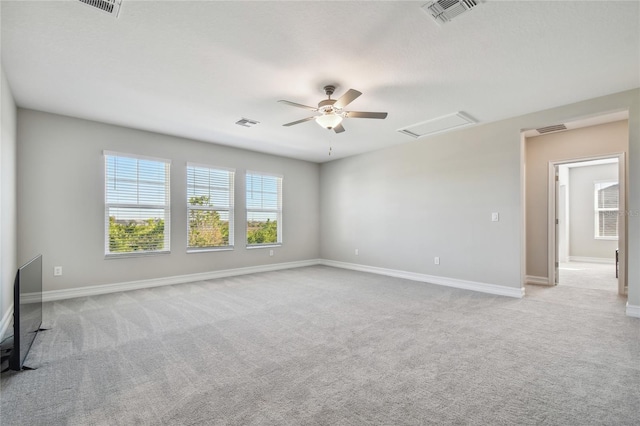 empty room featuring light colored carpet and ceiling fan