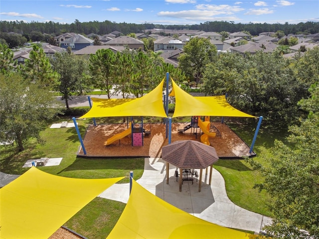 view of home's community featuring a playground and a lawn