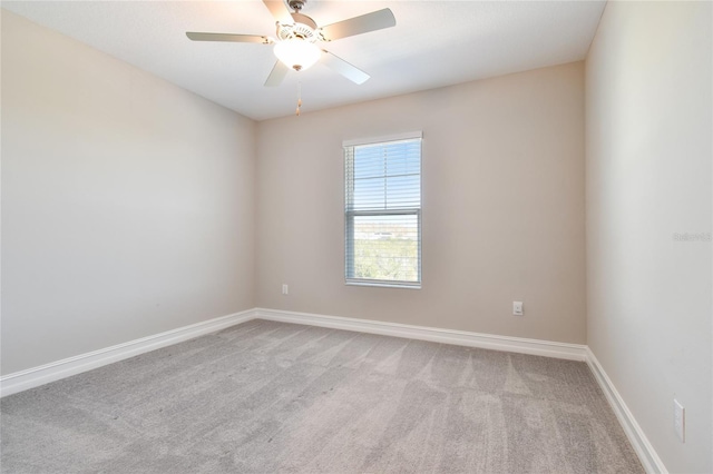 unfurnished room with ceiling fan and light colored carpet