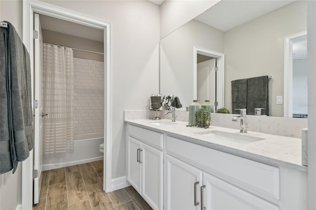 full bathroom featuring toilet, wood-type flooring, vanity, and shower / tub combo with curtain