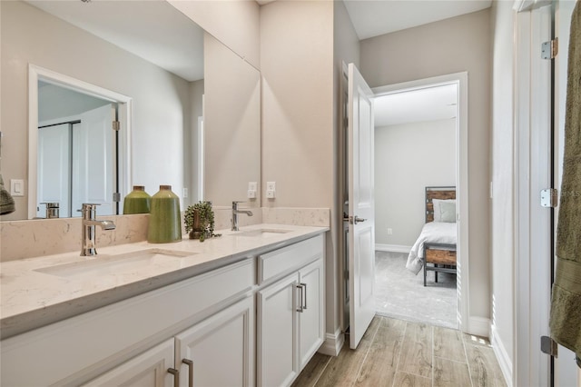 bathroom with vanity and wood-type flooring