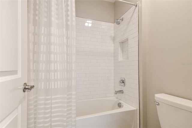 bathroom featuring toilet and shower / tub combo with curtain