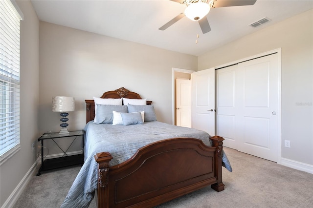 bedroom featuring light carpet, a closet, and ceiling fan