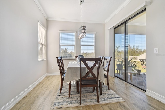 21291 Snowy Orchid Ter, Land O Lakes, FL 34637 - dining space featuring light wood-style floors, crown molding, baseboards, and a chandelier
