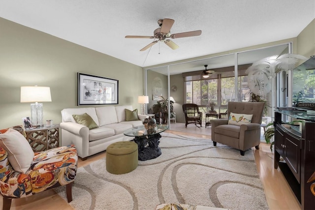 living room featuring light wood-type flooring and ceiling fan