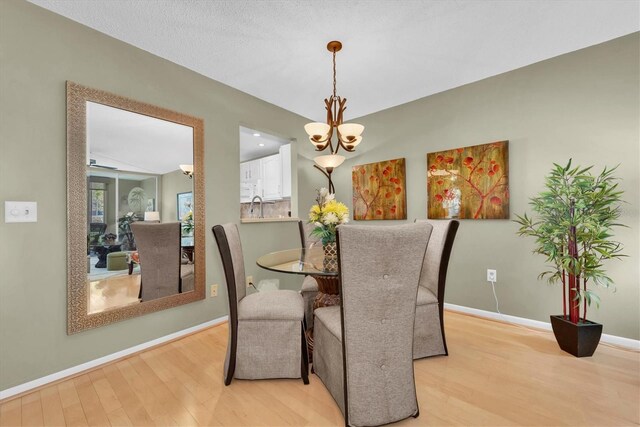 dining room with a chandelier and light hardwood / wood-style flooring