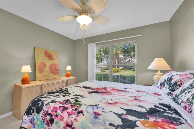 carpeted bedroom with ceiling fan and lofted ceiling