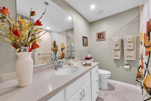 bathroom with vanity, toilet, and curtained shower