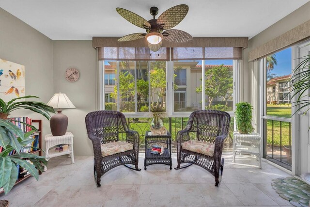 sunroom / solarium featuring ceiling fan