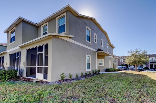 view of side of property with a lawn