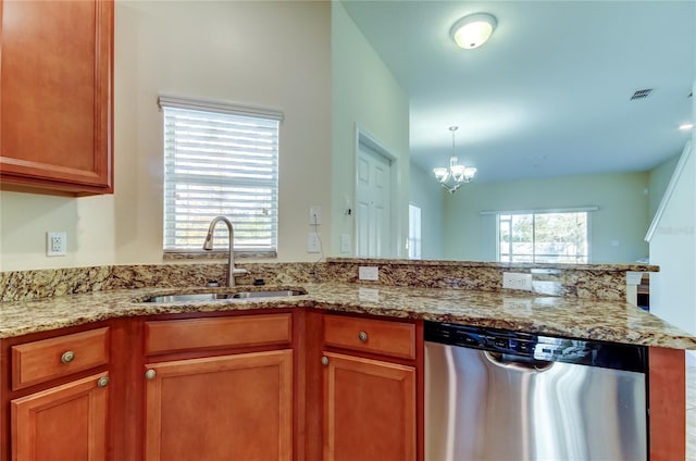 kitchen featuring dishwasher, plenty of natural light, sink, and a chandelier