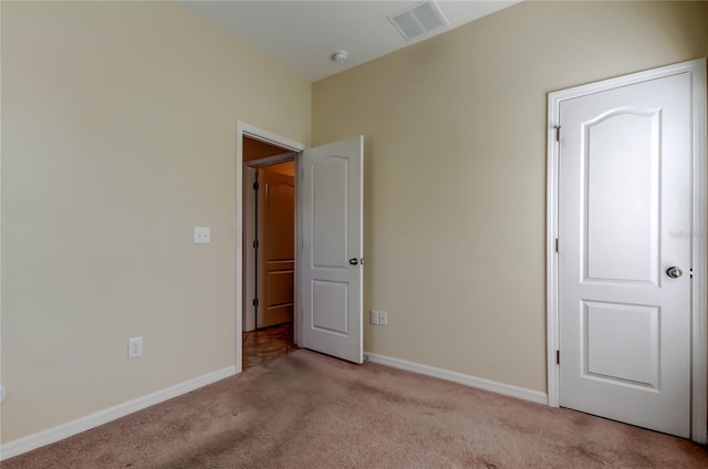 unfurnished bedroom with light carpet