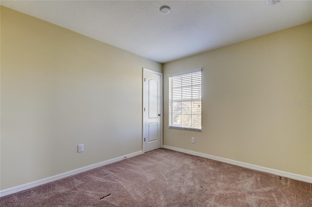 spare room featuring light colored carpet