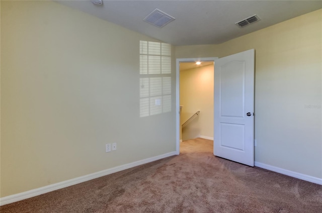 unfurnished room with light carpet