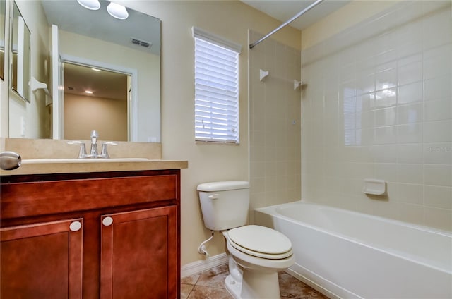 full bathroom featuring tile patterned floors, vanity, toilet, and tiled shower / bath