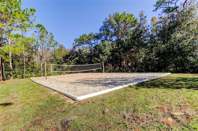 surrounding community featuring a yard and volleyball court