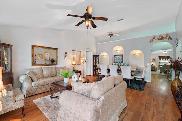 living room with hardwood / wood-style flooring, vaulted ceiling, and ceiling fan