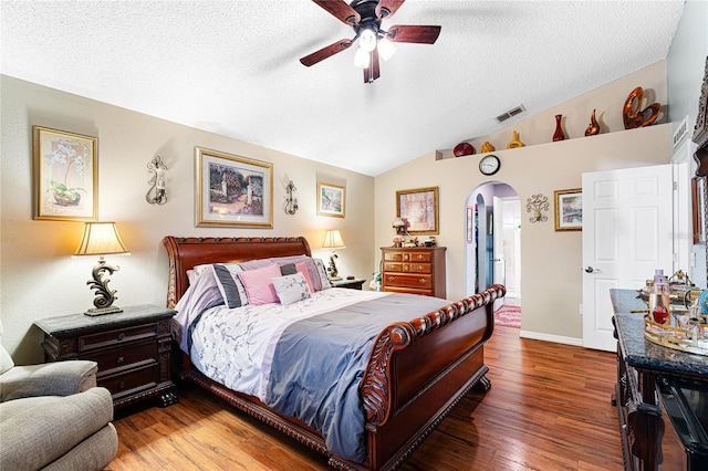 bedroom with hardwood / wood-style flooring, ceiling fan, lofted ceiling, and a textured ceiling