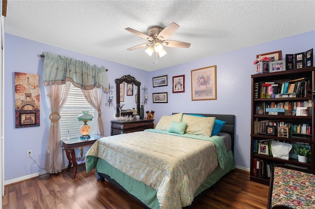 bedroom with a textured ceiling, ceiling fan, and dark wood-type flooring