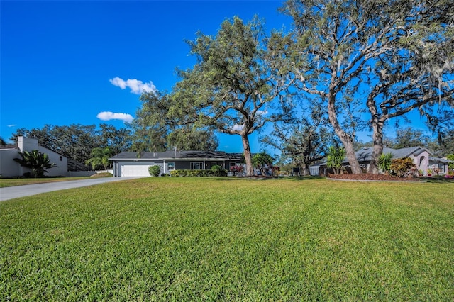 exterior space with a garage and a front lawn