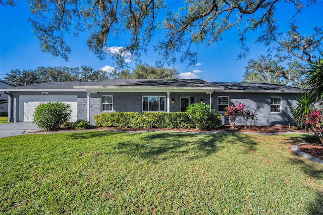 ranch-style house featuring a front yard and a garage