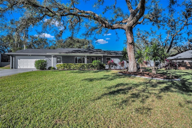 ranch-style home featuring a front yard and a garage