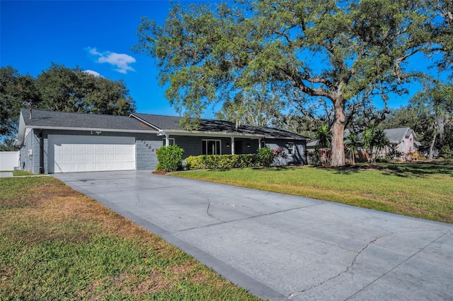 ranch-style home with a garage and a front lawn