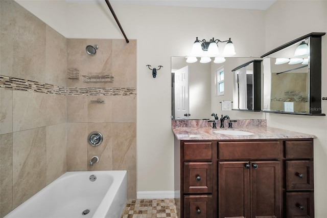 bathroom featuring vanity and tiled shower / bath