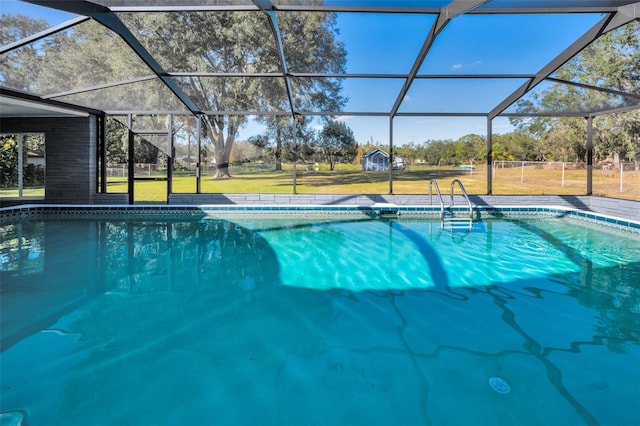 view of swimming pool featuring glass enclosure and a lawn