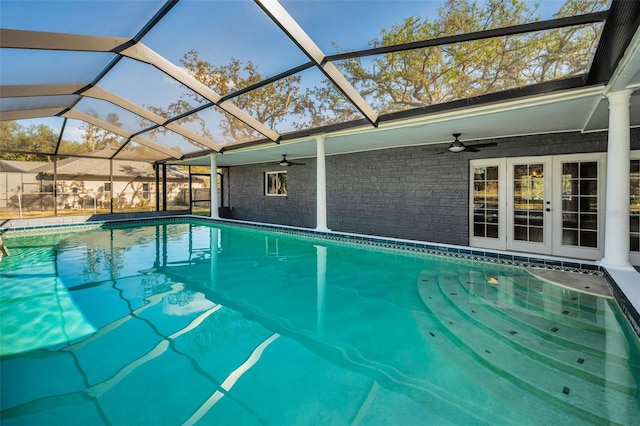 view of swimming pool with glass enclosure and ceiling fan