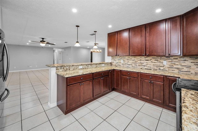 kitchen featuring backsplash, ceiling fan, decorative light fixtures, light tile patterned flooring, and kitchen peninsula