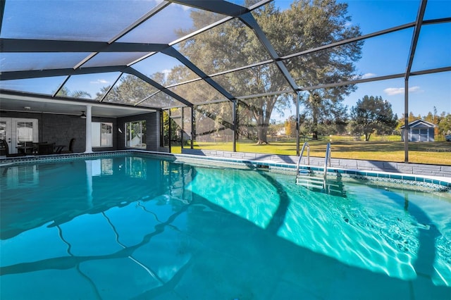 view of pool featuring ceiling fan and glass enclosure