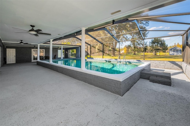 view of swimming pool with glass enclosure and a patio